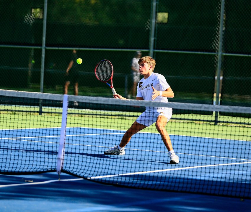 Arapahoe's Jack Winslow prepares for a half-volley during his No. 3 singles match against Rocky Mountain's Bailey Livengood in the opening round of the state 5A team tennis tournament at deKoevend Park Sept. 28. Winslow won the match in straight sets, and the Warriors advanced to the second round by beating the Lobos 4-3.
